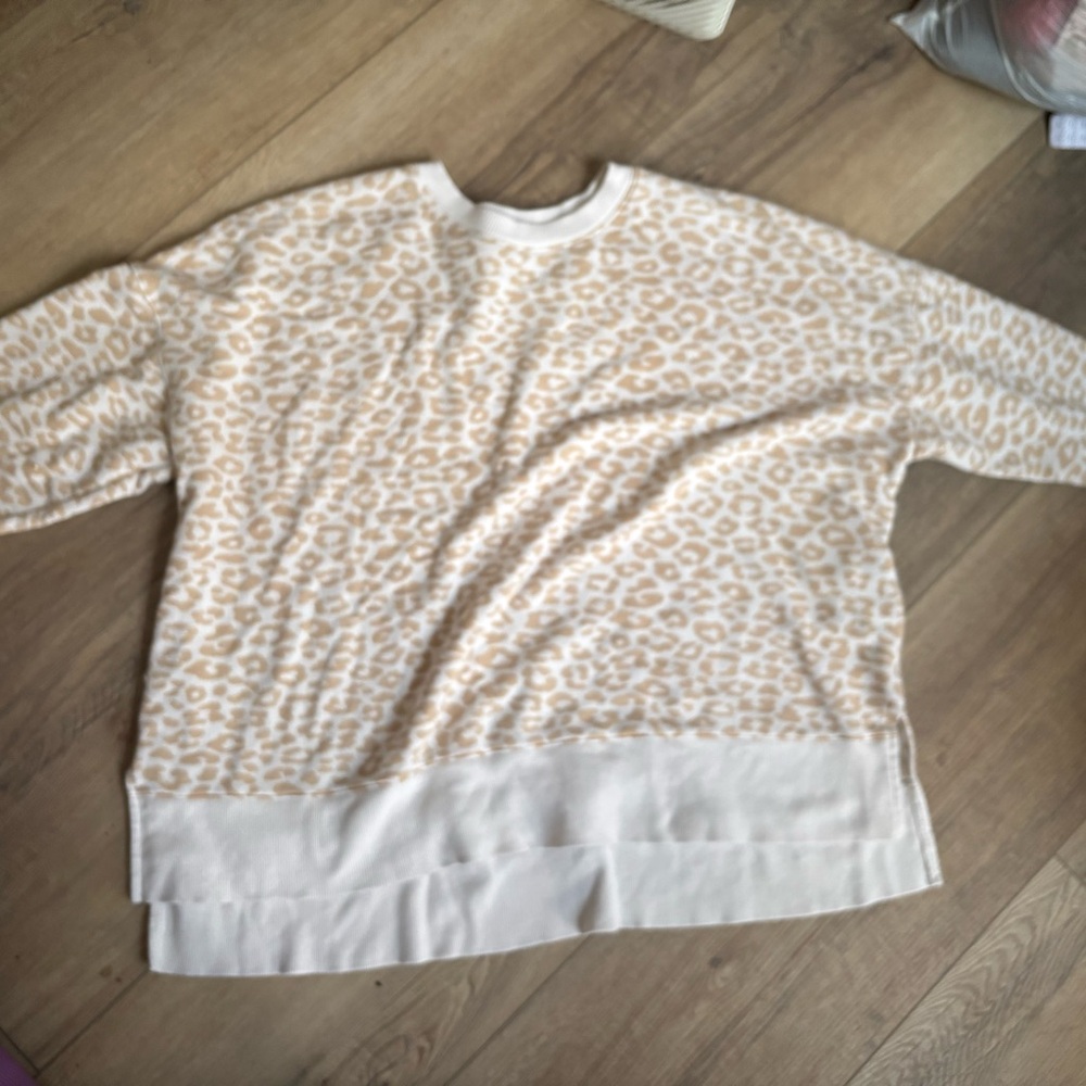 cream and white leopard print sweatshirt.